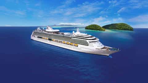 A large white cruise ship sails on a blue ocean near tropical islands - Brilliance Of The Seas, Royal Caribbean