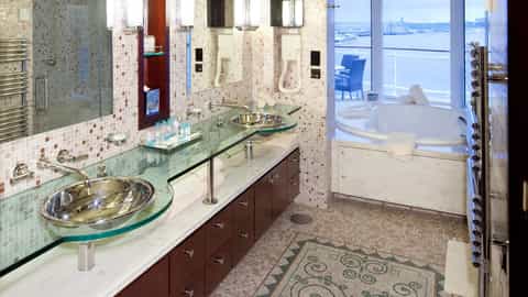 A bathroom with a jacuzzi and a view of the water - Celebrity Constellation, Celebrity Cruises