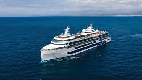 A large white cruise ship sails on the blue ocean - Celebrity Flora, Celebrity Cruises