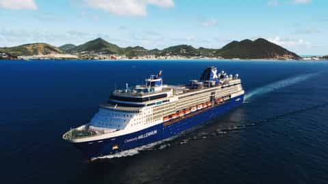 A large cruise ship sails on the ocean near a tropical island - Celebrity Millennium, Celebrity Cruises