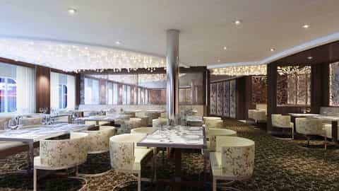 An elegant dining room with set tables and decorative lighting - Celebrity Solstice, Celebrity Cruises