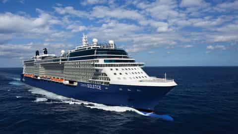 A large blue cruise ship sails on the ocean - Celebrity Solstice, Celebrity Cruises