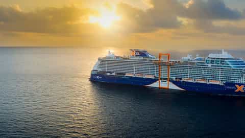 A large cruise ship sails on the ocean at sunrise - Celebrity Xcel, Celebrity Cruises