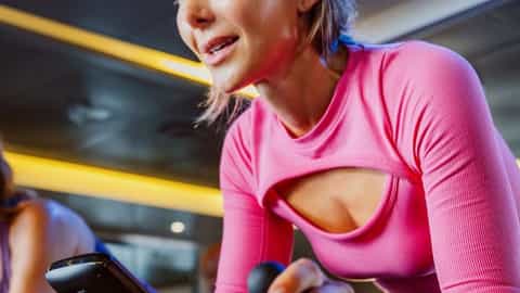 People exercising on stationary bikes in a gym - Discovery Princess, Princess Cruises