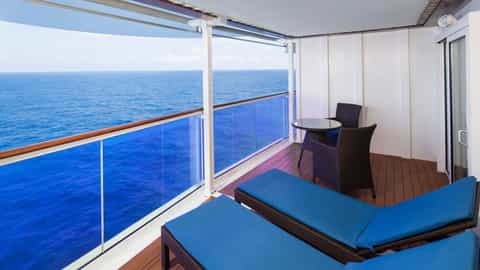 A private balcony with two lounge chairs and a table - Adventure Of The Seas, Royal Caribbean