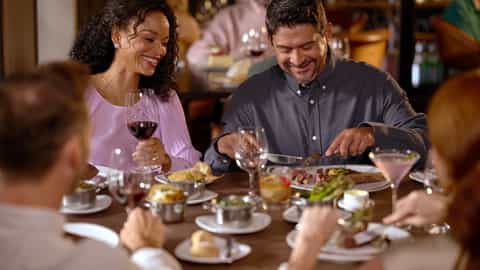 A couple enjoys a steak dinner with wine - Enchantment Of The Seas, Royal Caribbean