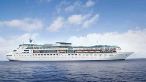 A large cruise ship sails on the ocean under a blue sky - Grandeur Of The Seas, Royal Caribbean
