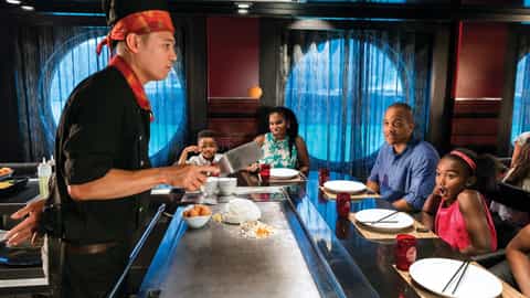 A chef cooks for a family at a hibachi grill - Harmony Of The Seas, Royal Caribbean