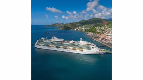 Cruise ship docked in a tropical port with mountains - Jewel Of The Seas, Royal Caribbean