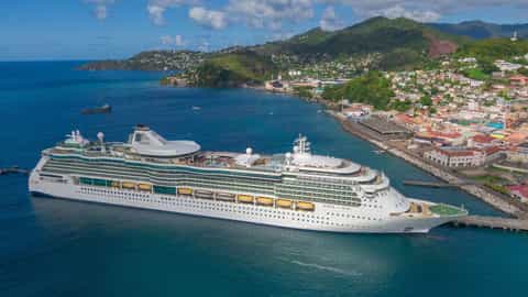 A large cruise ship is docked in a tropical port - Jewel Of The Seas, Royal Caribbean