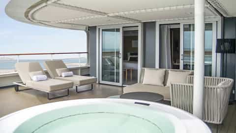 A private balcony with a hot tub and lounge chairs - Le Bellot, Ponant Cruises