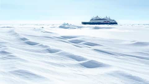 A ship sails through a vast ice field - Le Commandant Charcot, Ponant Cruises