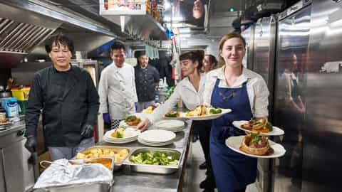 Kitchen staff prepare and serve plated meals - Lord of the Glens, Lindblad Expeditions