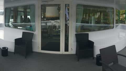 Outdoor seating area with chairs and tables on a deck - ms Fernao de Magalhaes, CroisiEurope