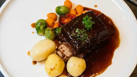 A plate of beef short ribs with potatoes and vegetables - MS Geoffrey Chaucer, Riviera Travel