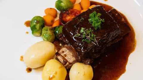 Braised beef with potatoes, Brussels sprouts, carrots, and tomato - MS Geoffrey Chaucer, Riviera Travel