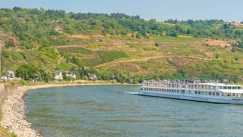 A river ship sails past a village and vineyards - ms Gerard Schmitter, CroisiEurope