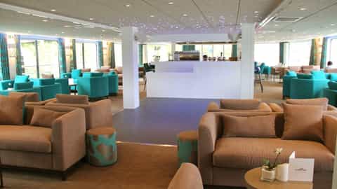 A spacious lounge with a bar and ample seating - ms Gil Eanes, CroisiEurope