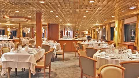 A formal dining room with tables set for a meal - ms L'Europe, CroisiEurope