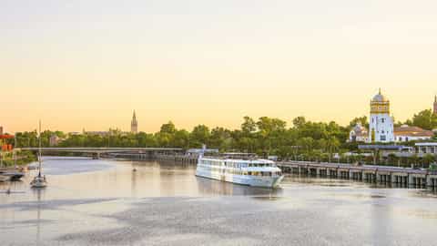 A river ship sails past a European city skyline - ms La Belle de Cadix, CroisiEurope
