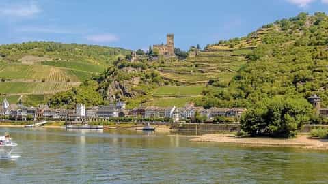 A river ship sails past a castle and vineyards - ms Leonard de Vinci, CroisiEurope