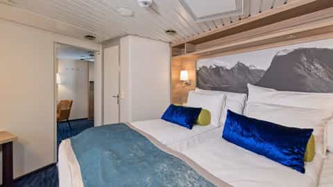 A cabin with two beds and a mountain mural - MS Nordkapp, Hurtigruten
