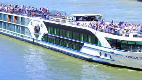 A river cruise ship with passengers on deck - MS Oscar Wilde, Riviera Travel