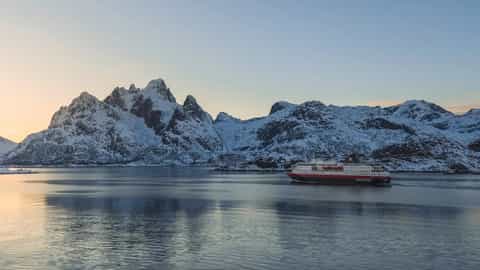 A ship sails past snow-covered mountains - MS Richard With, Hurtigruten
