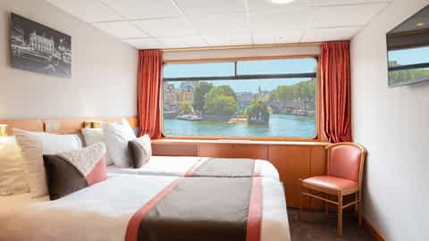 Two beds in a cabin with a river view outside - ms Seine Princess, CroisiEurope