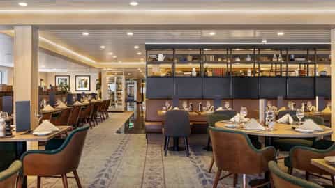 A dining room with tables set for a meal - MS Spitsbergen, HX Expeditions