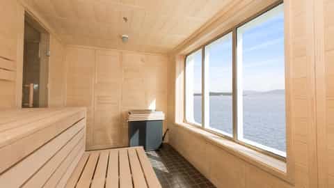 A wooden sauna with large windows overlooking the ocean - MS Spitsbergen, HX Expeditions