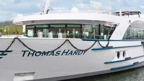 A white river boat named Thomas Hardy sails on the water - MS Thomas Hardy, Riviera Travel