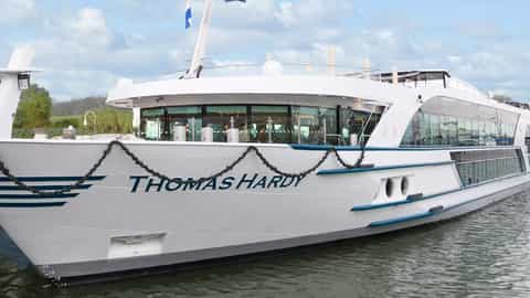 A white river boat named Thomas Hardy sails on the water - MS Thomas Hardy, Riviera Travel