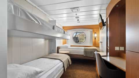 A cabin with bunk beds, a desk, and a round window - MS Trollfjord, Hurtigruten