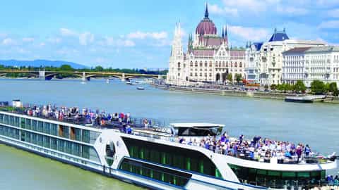A river ship sails past the Hungarian Parliament Building - MS William Wordsworth, Riviera Travel