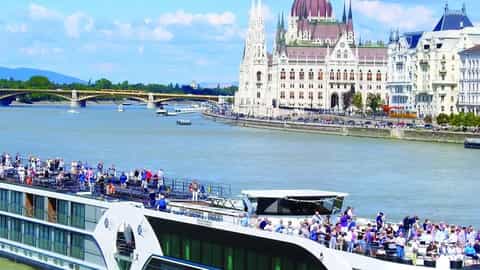 A river ship sails past Budapest landmarks - MS William Wordsworth, Riviera Travel