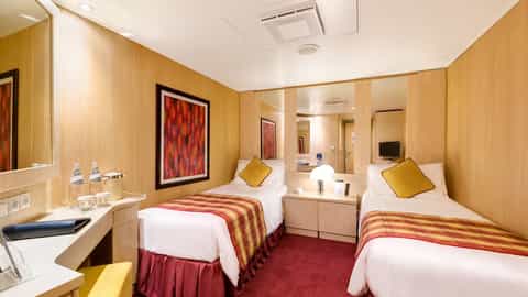 A cabin with two beds, a desk, and artwork - MSC Armonia, MSC Cruises