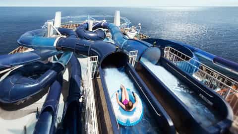 A person rides a water slide on a cruise ship - MSC Meraviglia, MSC Cruises