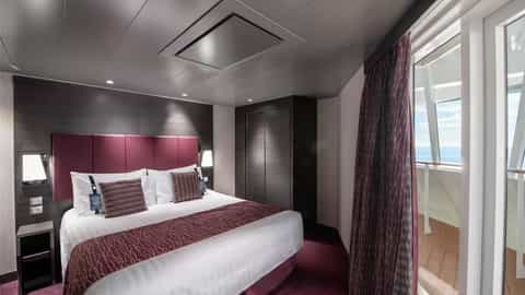 A well-appointed suite bedroom with a balcony view - MSC Meraviglia, MSC Cruises