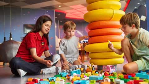 Children play with toys and building blocks with an attendant - MSC Musica, MSC Cruises