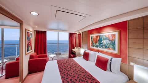 A cruise ship suite bedroom with a balcony overlooking the ocean - MSC Musica, MSC Cruises