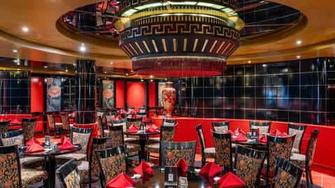 A formal dining room with many tables set for dinner - MSC Orchestra, MSC Cruises