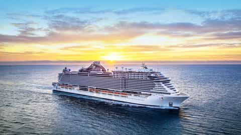 A large cruise ship sails on the ocean at sunset - MSC Seaside, MSC Cruises
