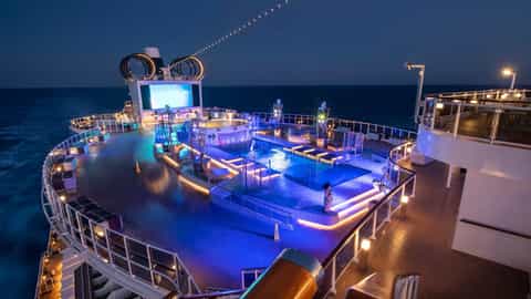 A cruise ship pool deck is illuminated at night - MSC Seaview, MSC Cruises