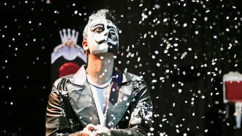 A performer with dramatic face paint looks up as confetti falls - MSC Splendida, MSC Cruises