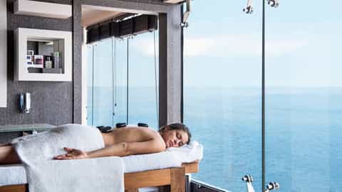 Woman receives a hot stone massage with ocean view - MSC Splendida, MSC Cruises
