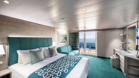 A modern suite bedroom with a balcony overlooking the ocean - MSC Virtuosa, MSC Cruises