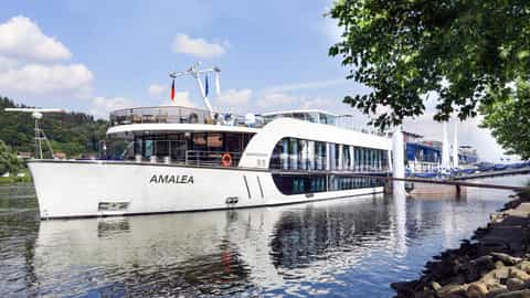 A white river cruise ship is docked on a sunny day - AmaLea, AmaWaterways