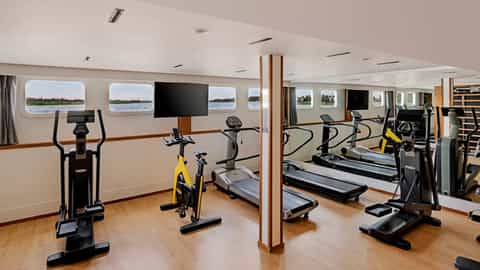 A gym with treadmills, ellipticals, and stationary bikes - AmaLilia, AmaWaterways