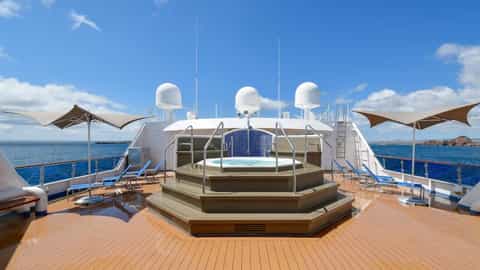 A jacuzzi and lounge chairs on a ship's deck - National Geographic Gemini, Lindblad Expeditions